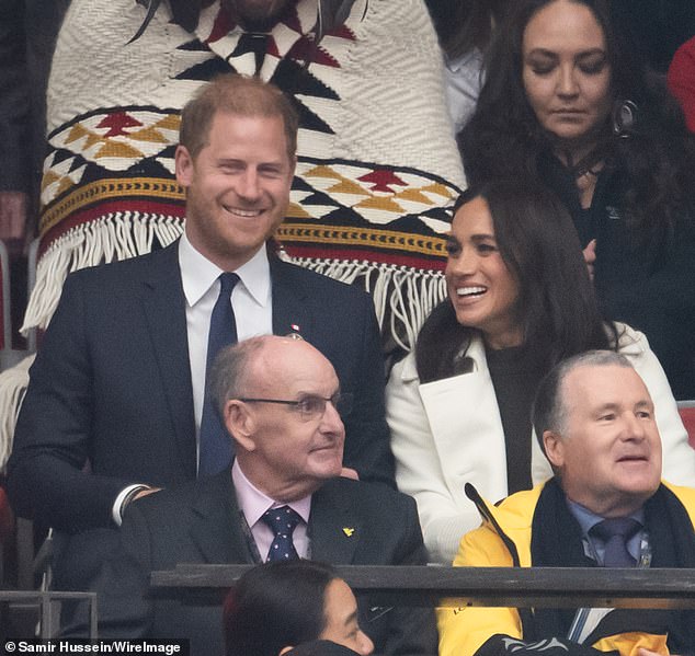 Prince Harry smiles with his wife Meghan at the Invictus Games ceremony on Saturday