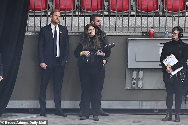 Standing on the sidelines: The Duke of Sussex prepares to speak to the packed-out stadium