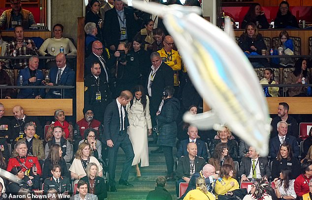 Prince Harry and Meghan Markle enter the ceremony to an outburst of cheers from the crowd