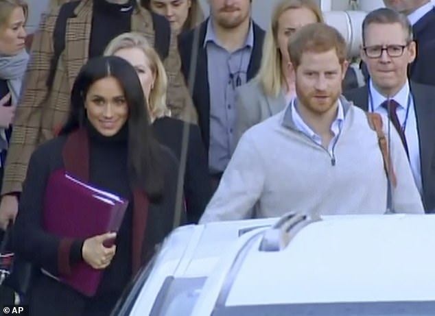 Meghan first wore the Givenchy coat in October 2018 after she touched down in Sydney with Prince Harry (pictured)