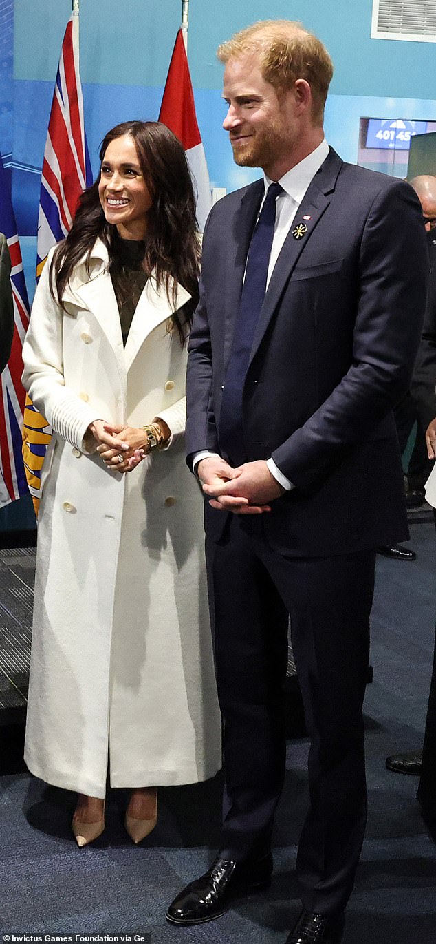 When meeting notable figures at the games, Meghan donned a chic £2,400 'Baby Alpaca Maxi Trench Coat' in 'Ivory' from Sentaler