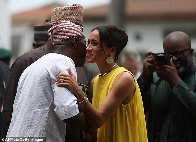 Misan Harriman photographed Meghan during her trip to Nigeria with Prince Harry in May last year. Above: Harriman seen right with his camera as the Duchess of Sussex greets Lagos state governor Babajide Sanwo-Olu