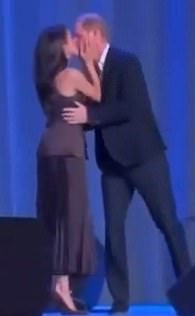 The couple lovingly kiss on stage after Harry's speech