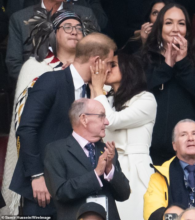 The former actress places a hand on Harry's cheek as she plants a kiss on his lips in Vancouver