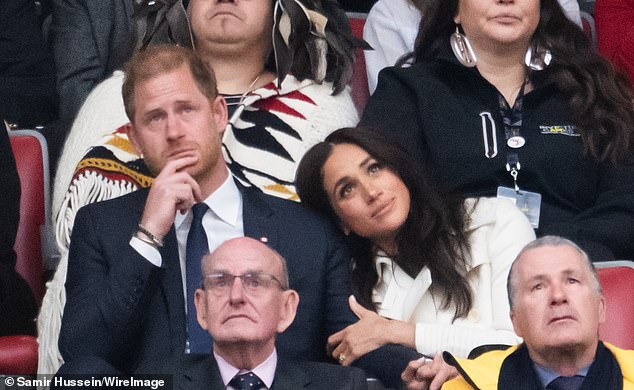 During the opening ceremony of the sporting event, Meghan placed her head on Harry's shoulder and clung to his arm