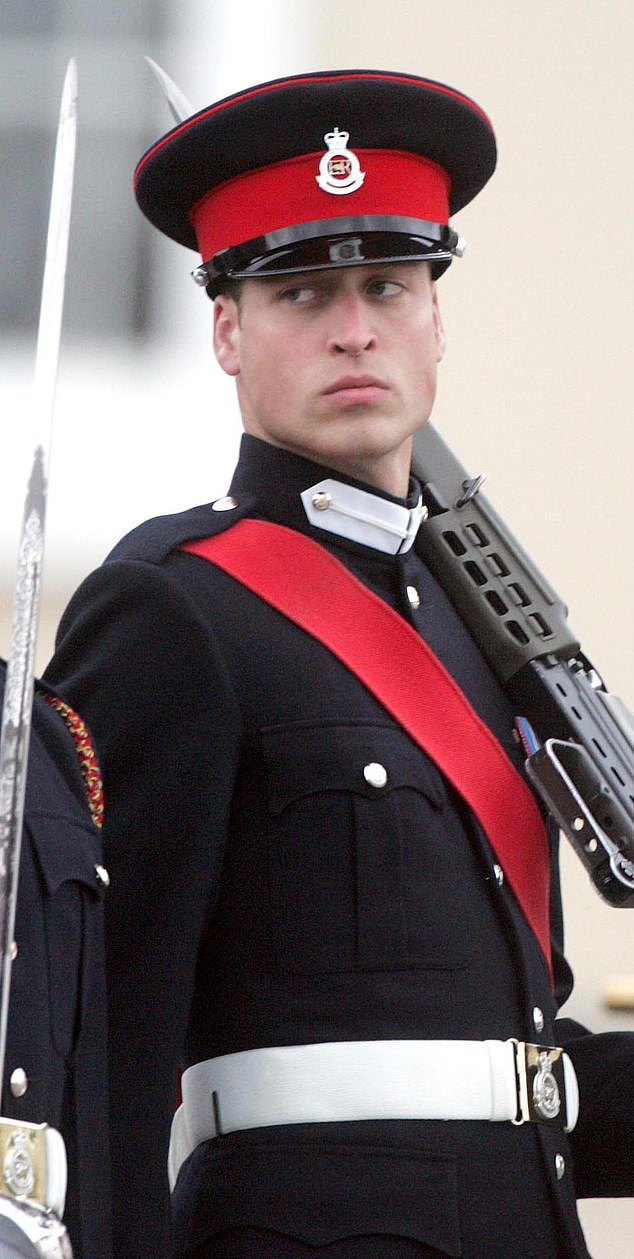 A young Prince William is seen wearing a blue uniform, hat and white gloves with a scarlet-coloured sash at the parade