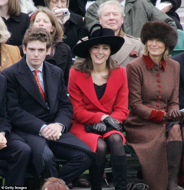 Kate, who was 24-years-old at the time, sitting with James Meade (left) and her mother Carole in the front row. She is wearing a scarlet coat and extravagant black hat by Phillip Tracey