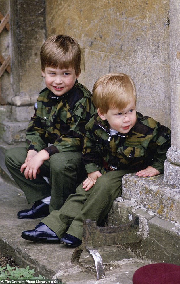 Prince William and Prince Harry sit together at the steps of Highgrove wearing military uniforms in July 1986