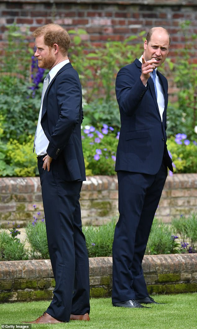 Prince Harry and the Duke of Sussex are seen speaking to a gardener as they unveil a statue of their mother in 2021