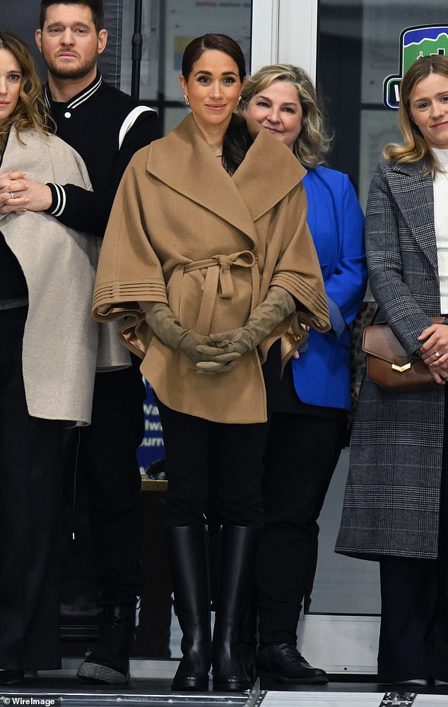 Meghan kept the cold at bay in a cosy camel cape by Sentaler during the 2024 Invictus Games One Year To Go Winter Training Camp in Canada