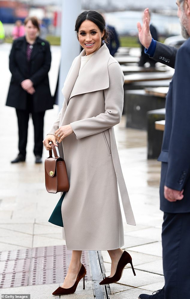 Meghan looked effortlessly elegant in the Mackage 'Mai' belted coat during a visit to Belfast in March 2018