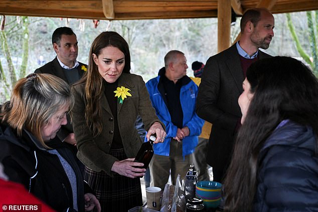 William and Kate listened on as community volunteers explained how to make medicinal balms with plants from the garden