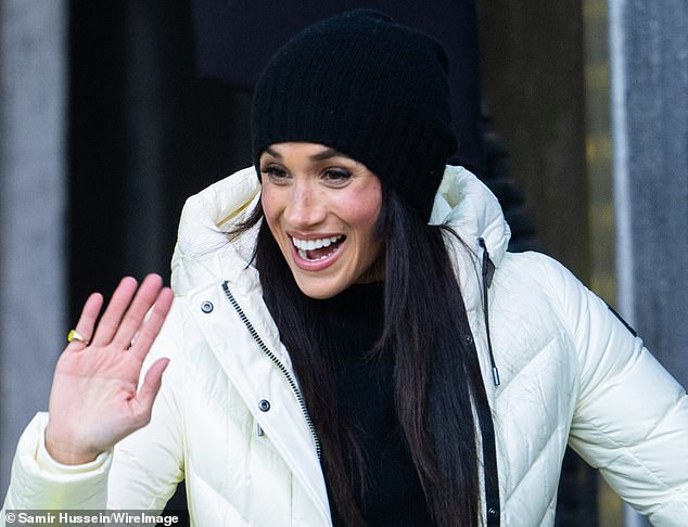 Meghan waves for fans at the games with her signet ring clear for all to see