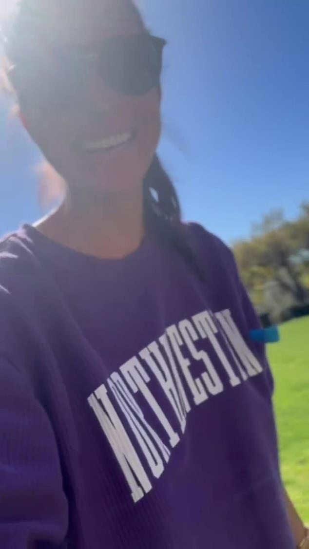 Meghan wore a sweater from Northwestern University matching her late mother-in-law's from the 1990s in an Instagram video titled: 'A small break from work to soak in the weekend sunshine'