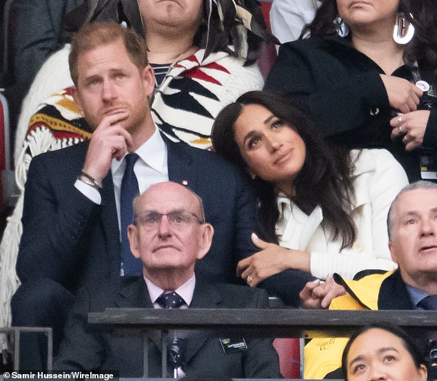 Pictured: Meghan Markle snuggling up to Prince Harry on 8 February at the Invictus Games opening ceremony in Vancouver