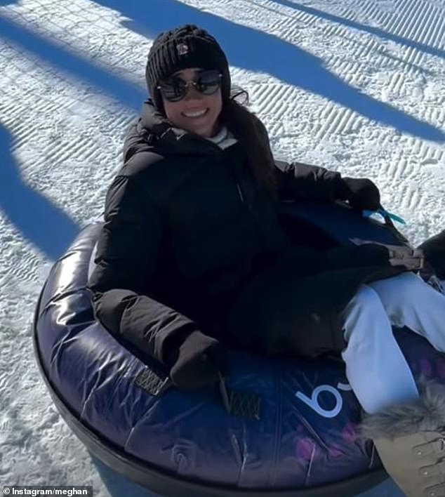 Meghan Markle showed she was a good sport as she took the plunge and raced down a ski slope in a rubber tube today