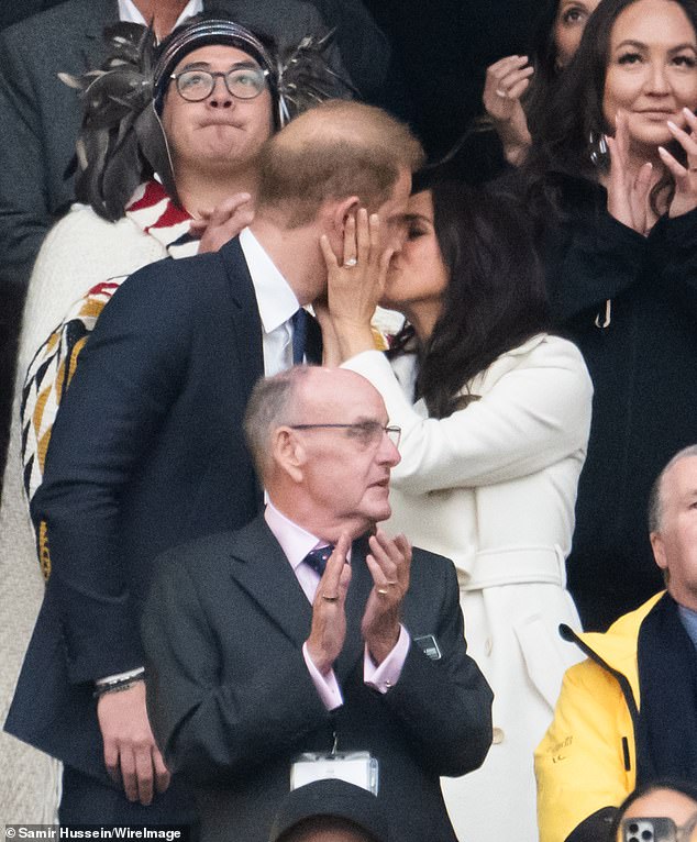 Prince Harry, Duke of Sussex and Meghan, Duchess of Sussex kiss during the opening ceremony of the 2025 Invictus Games at BC Place in Vancouver