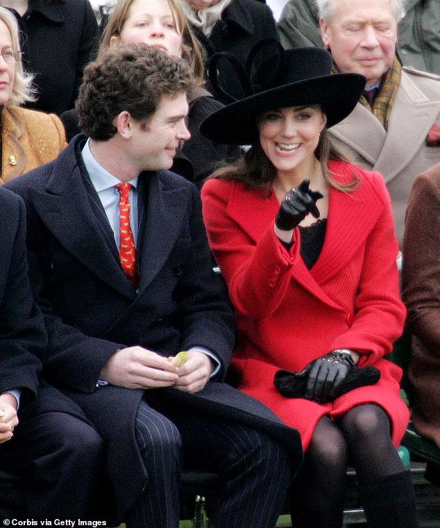 Kate Middleton, Prince William's then-girlfriend of several years, whispers to James Meade as she attends the passing-out parade at Sandhurst on December 15, 2006