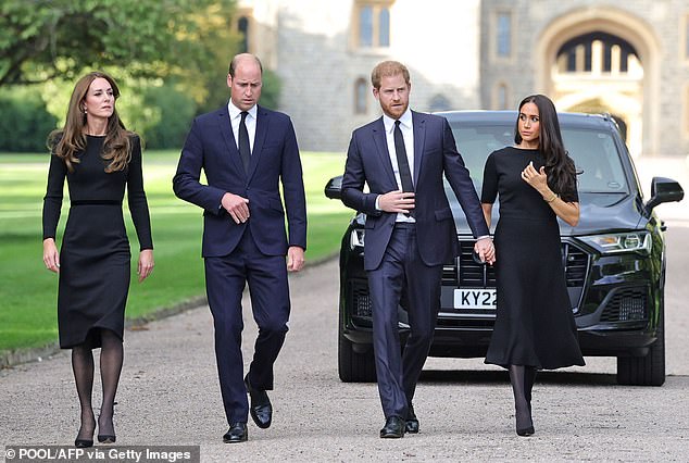 Catherine, Prince William, Prince Harry and Meghan on the Long Walk at Windsor Castle to greet royal fans