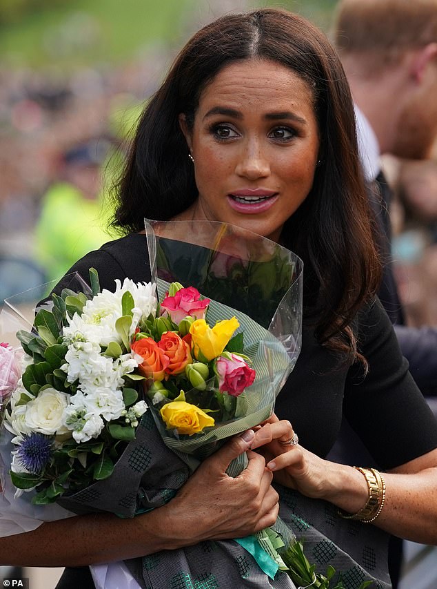 After a little to-ing and fro-ing, Meghan eventually did let go of the flowers