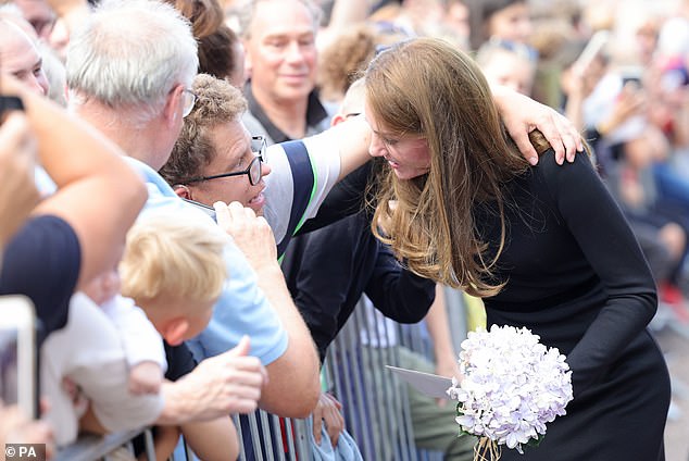 The Princess of Wales hugging a man over the barriers