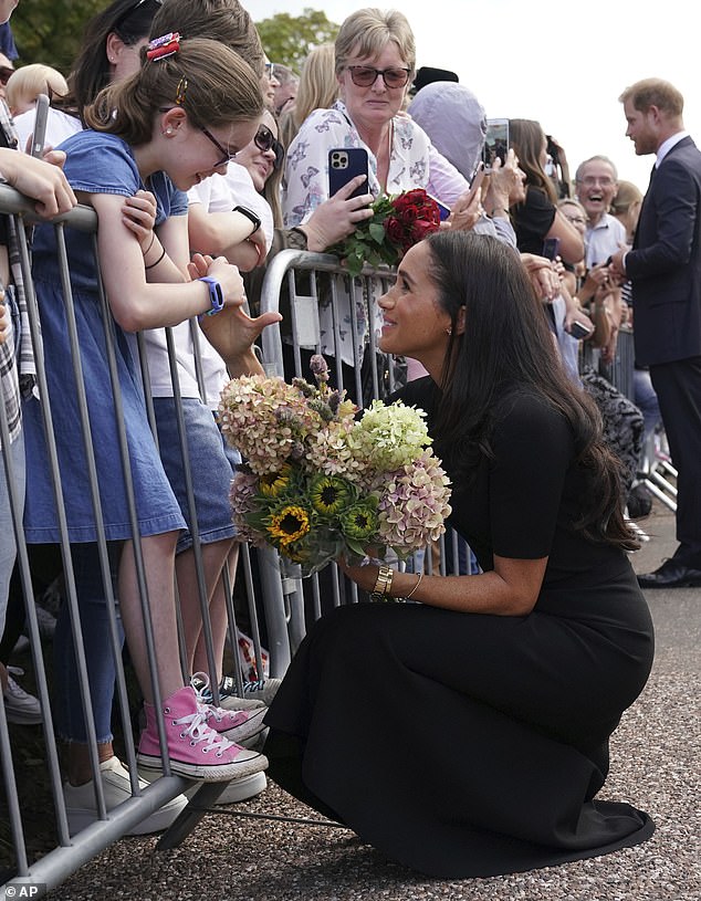 One excited little girl got special attention from Meghan who knelt down to clasp hands and share a kind smile