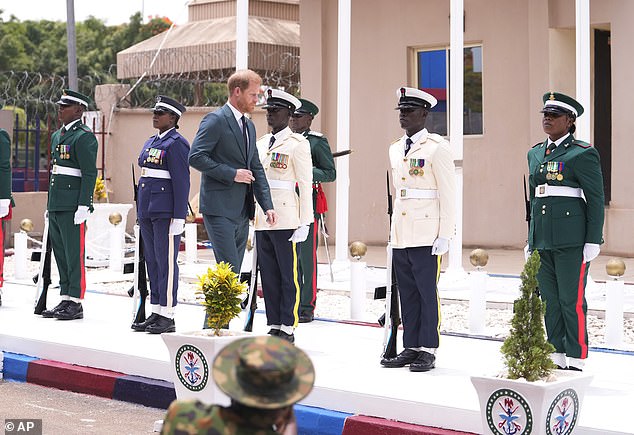 Prince Harry pictured being welcomed to the Defence Headquarters in Abuja, Nigeria