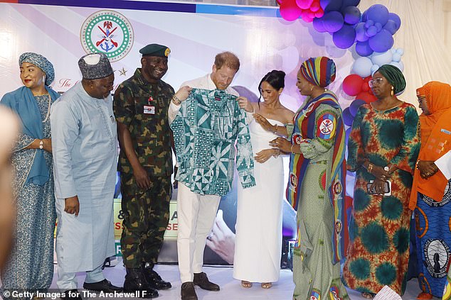 Prince Harry is gifted a shirt during the ceremony in Nigeria on May 11, 2024