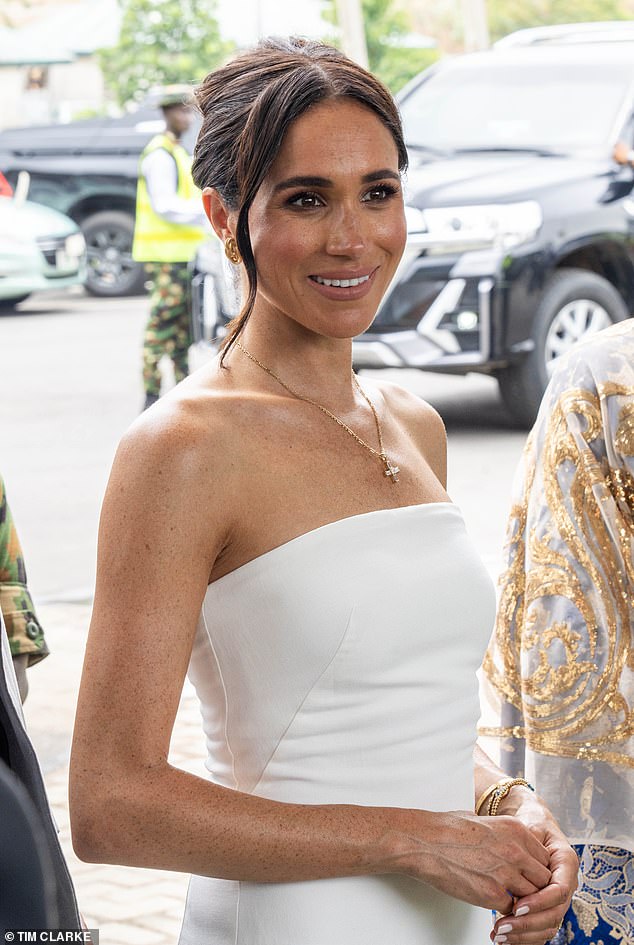 Meghan Markle wowed crowds in Nigeria as she wore a shoulderless St Agni full length white dress