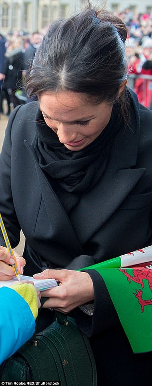 Meghan appeared to break protocol on the trip by signing an autograph