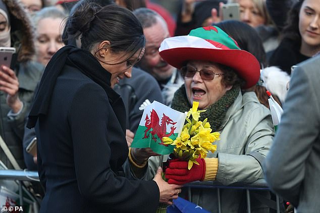 Meghan met delighted fans who had waited in the cold at Cardiff Castle during her walkabout