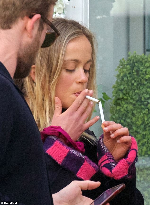 Mel, who is 44th in line to the British throne, lights a cigarette in May 2021