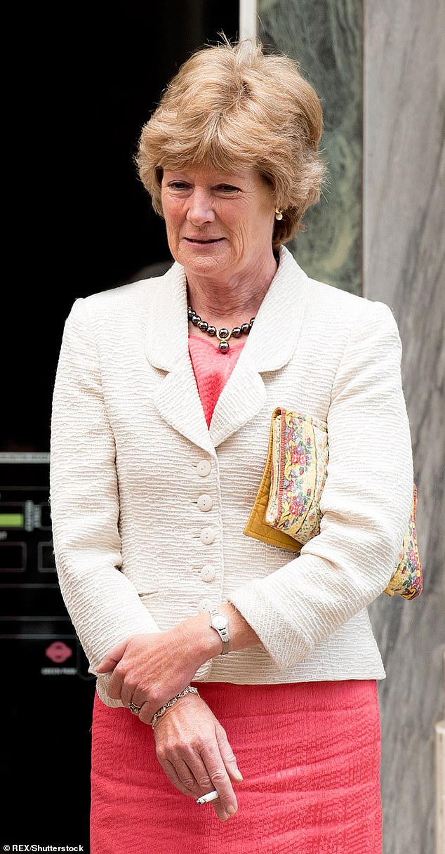 Lady Sarah, then 58, smokes a cigarette in 2013. She celebrated her 60th birthday with a huge cake in the shape of a packet of Silk Cut in tribute to her love of cigarettes