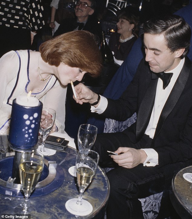 The eldest Spencer sister has her cigarette lit by a man in a dinner jacket and black tie