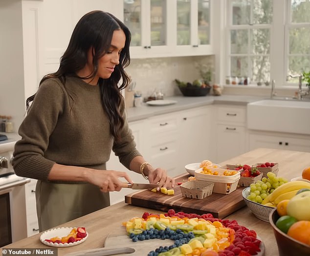 Meghan (pictured) started by placing fruits such as grapes, blueberries and strawberries on a chopping board before declaring 'you don't have to do a big platter of this... you could do this with one small row for your kids for breakfast'