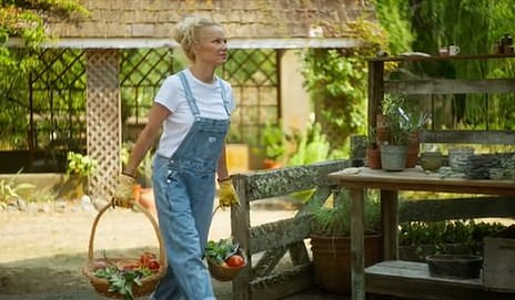 Pamela Anderson carrying wicker baskets of vegetables picked from her garden