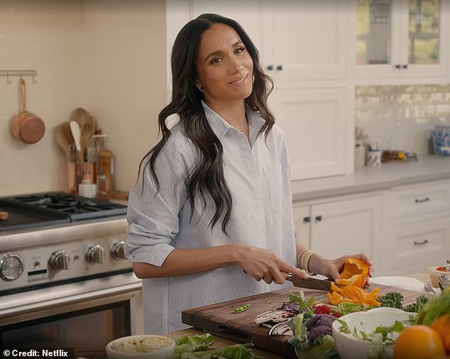 Here Meghan is seen chopping up peppers with a £134 Shun classic 'Blonde 7' knife while wearing an Anine Bing 'Mika' oversized shirt thought to be worth around £191