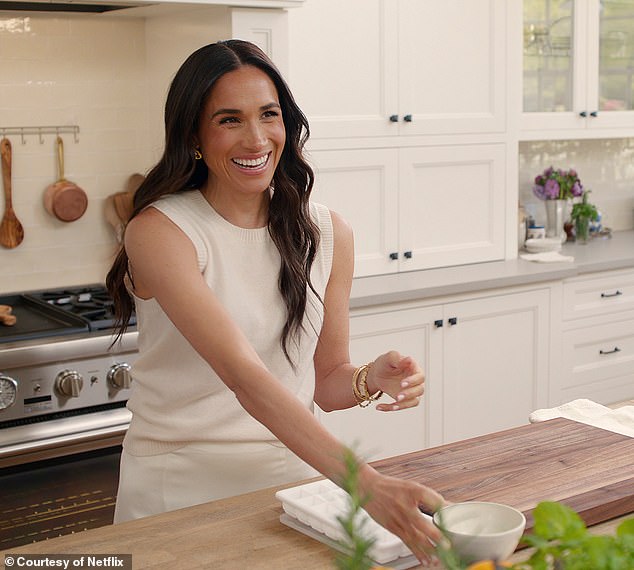 Pictured is a beaming Meghan, in the kitchen set for her new Netflix show