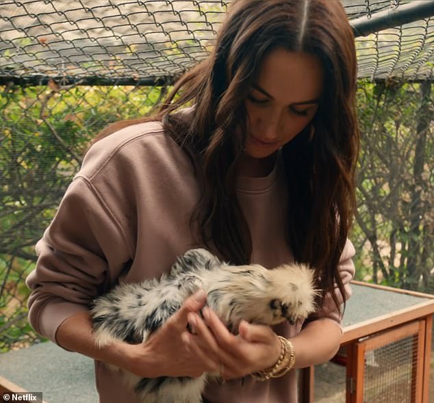 Meghan holds a chicken during an episode of her new Netflix show which came out on Tuesday