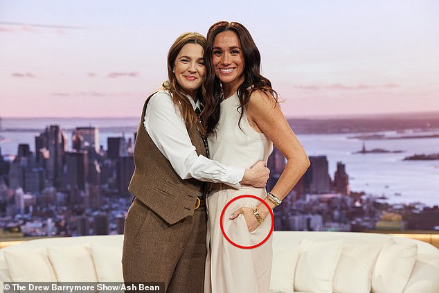 The former working Royal, 43, whose new Netflix series, With Love, Meghan, has been mocked by viewers , was seen awkwardly hugging the host, 50 while keeping her hand in her pocket