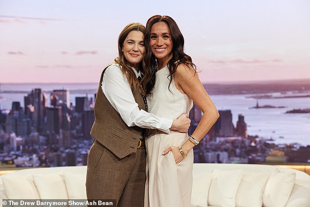 Markle's real reaction to 'relentlessly clingy' Barrymore has been revealed by a body language expert - the pair are pictured ahead of Markle's Thursday chat on the show