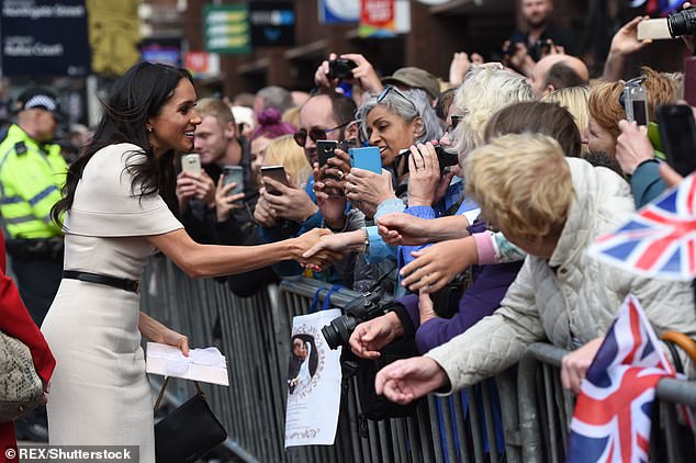 Meghan shaking hands as she walked on foot to Chester Town Hall