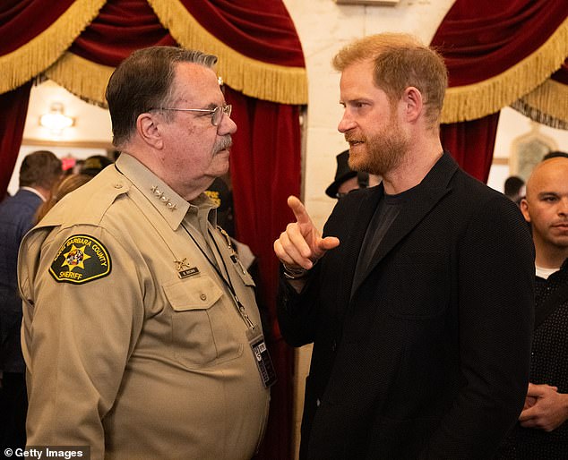 Harry appeared focused as he chatted with a member of Santa Clara County Sheriff at the event