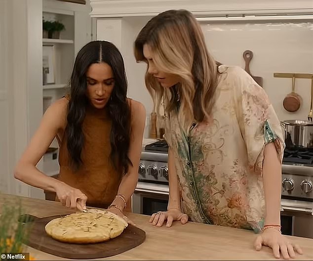 Meghan's motto throughout her Netflix eight-part show is 'playfulness over perfection' as she shows viewers how to bake the perfect focaccia (pictured with Delfina Figueras)