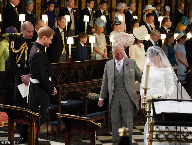Charles, then Prince of Wales, walks Meghan down the aisle as her own father could not attend