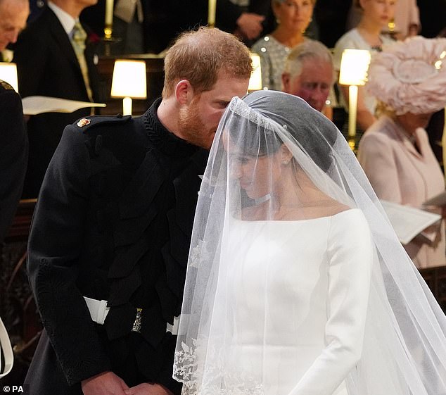 Harry is seen whispering sweet nothings to his bride at the altar