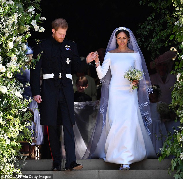 The newlyweds leave St George's Chapel after the ceremony to roaring crowds