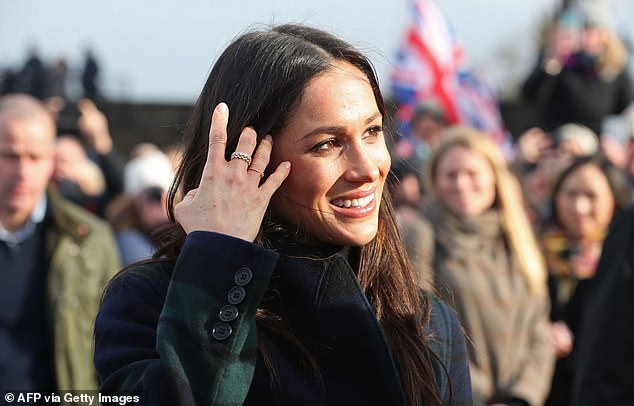 Meghan smiles as she meets members of the public in Edinburgh in February 2018. During visits Bower claims complaints were lodged that Meghan gave 'unroyal high-fives' and wore 'inappropriate clothes'