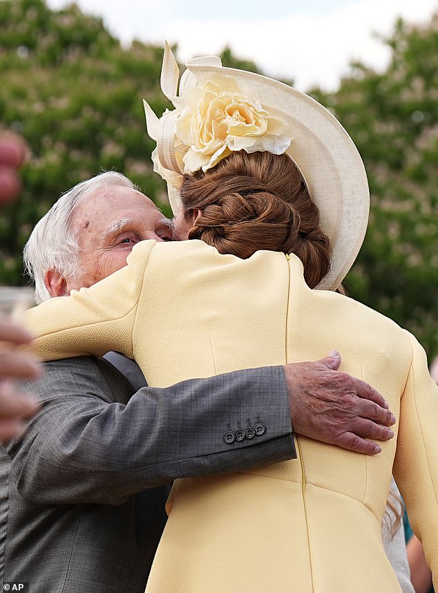 The Princess of Wales shared a warm embrace with a Holocaust survivor and his granddaughters as they reunited at a Buckingham Palace garden party yesterday