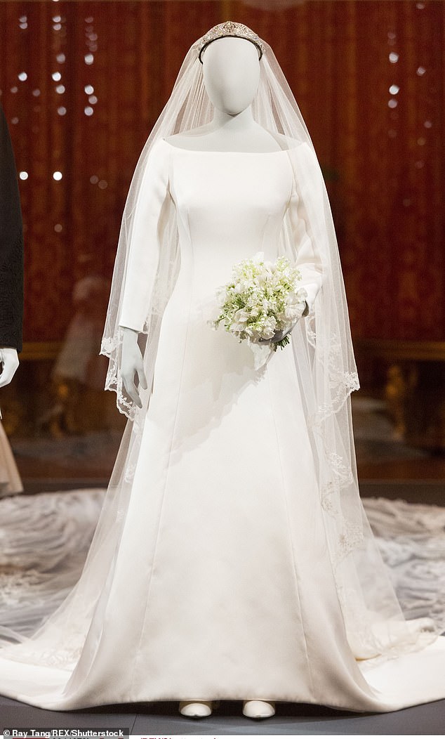 Meghan's wedding dress is pictured at The Royal Collection at Windsor Castle 'A Royal Wedding: The Duke and Duchess of Sussex' exhibition in October 2018